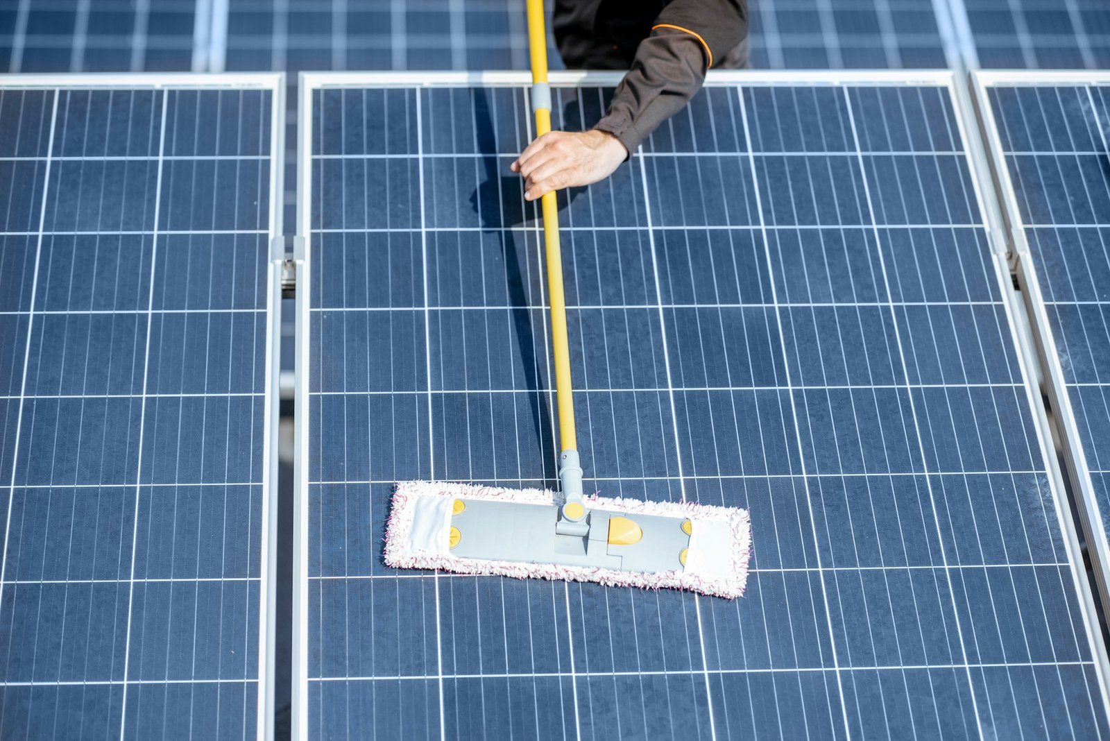 Workman cleaning solar panels